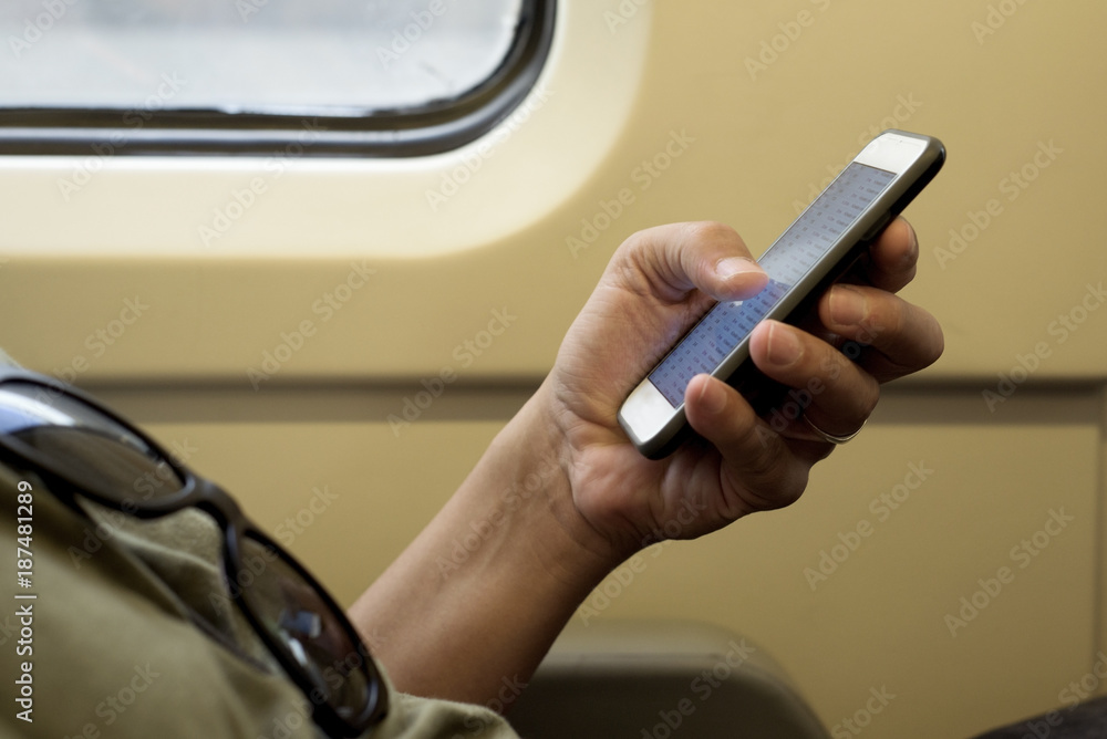 young man using a smartphone in a train or subway