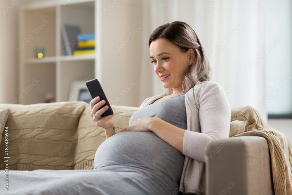 happy pregnant woman with smartphone at home happy pregnant woman with smartphone at home