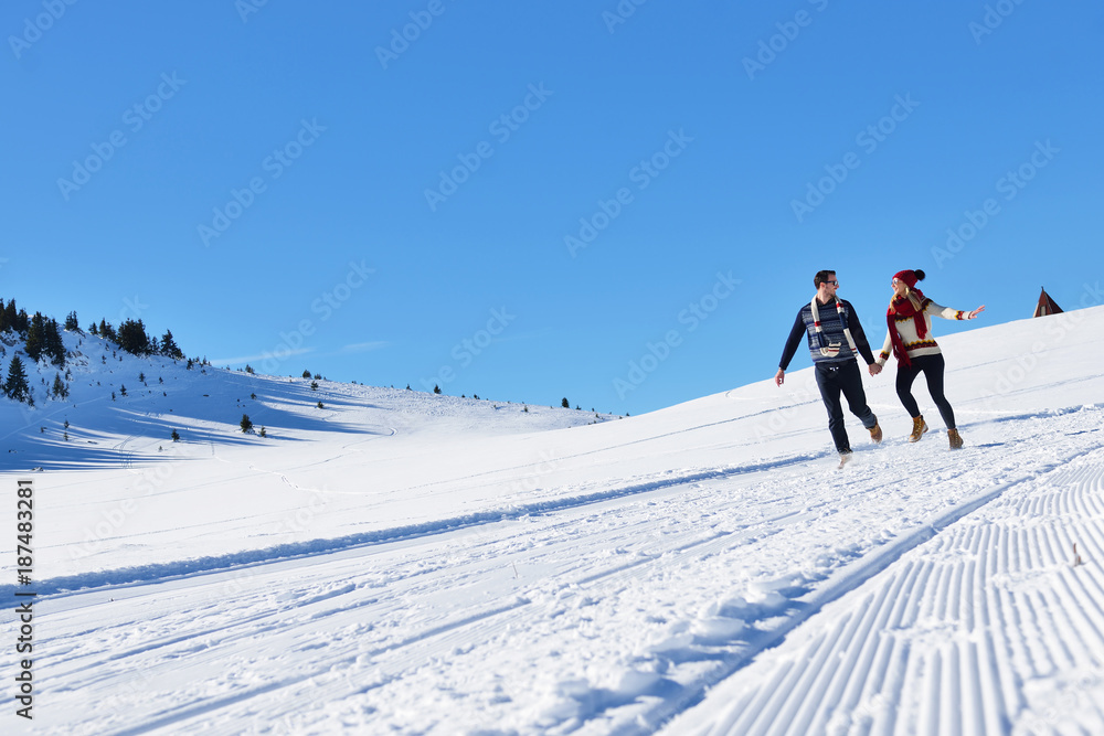 Couple having fun running down slope