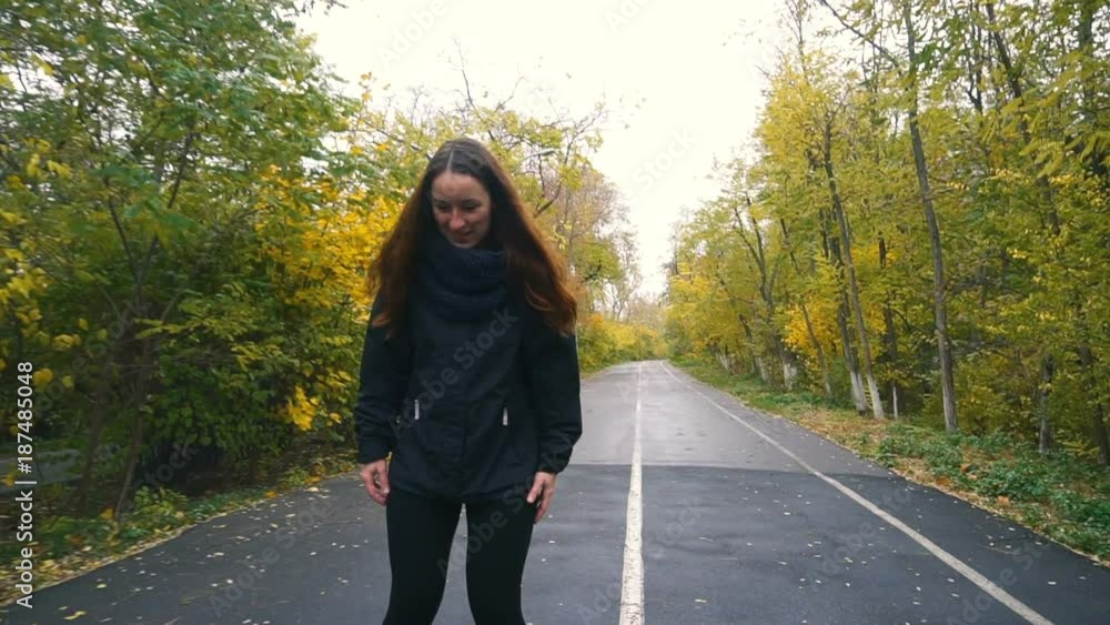 Young Woman On Roller skates among beautiful autumn trees Young Woman On Roller skates among beautiful autumn trees
