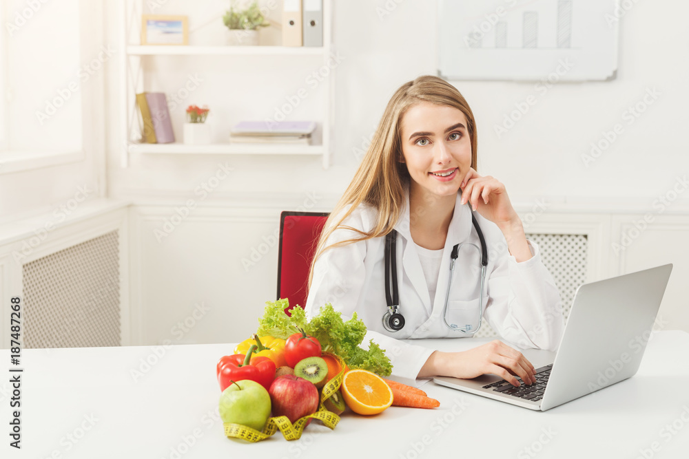 Female nutritionist working on laptop