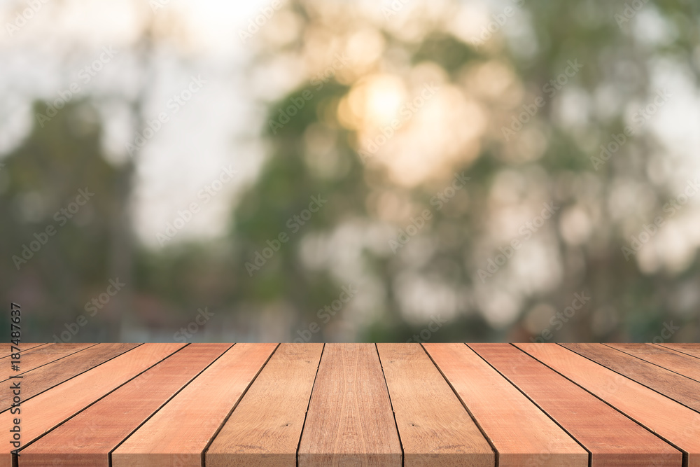Empty wood table top on nature green blurred background at garden,space for montage show products Empty wood table top on nature green blurred background at garden,space for montage show products