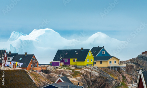 Huge icebergs stranded on the shores of the city of Iulissat, Greenland photo