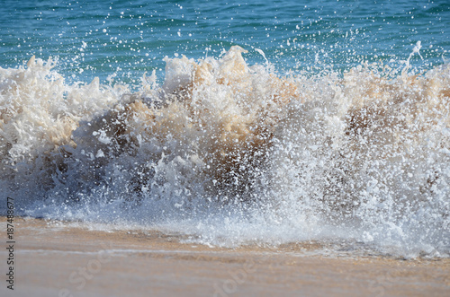 Waves breaking on the shore photo