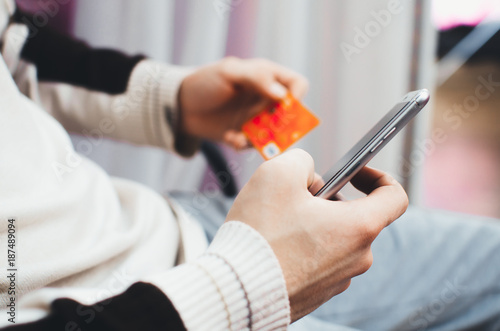 Foto men hands, holding the phone and a visa card or other