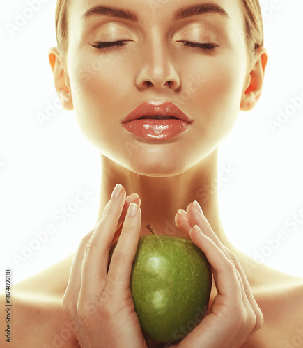 Young happy woman with green apple - isolated on white