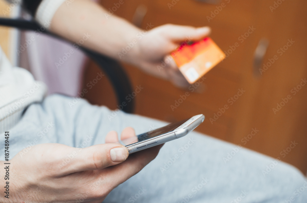 men hands, holding the phone and a visa card or other