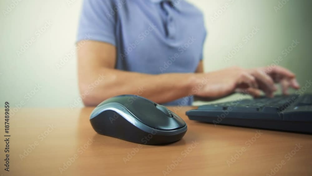 Close up of hands typing on computer keyboard and mouse Close up of hands typing on computer keyboard and mouse