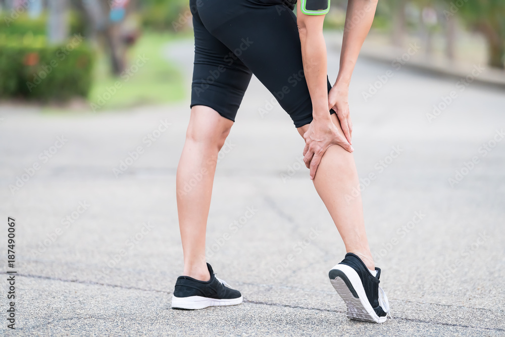 woman runner sports injured leg . Pain relief concept.