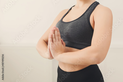 Unrecognizable woman practicing yoga in padmasana