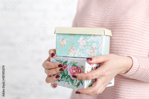 woman opens a box with gifts in the spring
