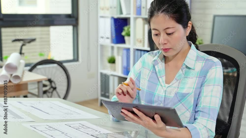 Asian female architect using tablet computer Asian female architect using tablet computer
