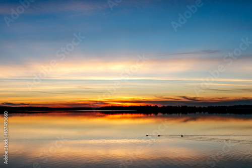 Sunset over lake Thunderbird, ducks swimming by.