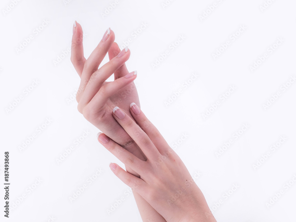 Close up of beautiful Woman Hands. Spa and Manicure concept. Female hands with french manicure. Soft skin, skincare concept. Beauty nails. over beige background Close up of beautiful Woman Hands. Spa and Manicure concept. Female hands with french manicure. Soft skin, skincare concept. Beauty nails. over beige background