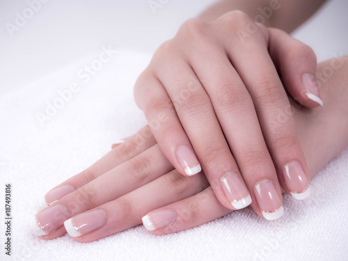Close up of beautiful Woman Hands. Spa and Manicure concept. Female hands with french manicure. Soft skin  skincare concept. Beauty nails. over beige background