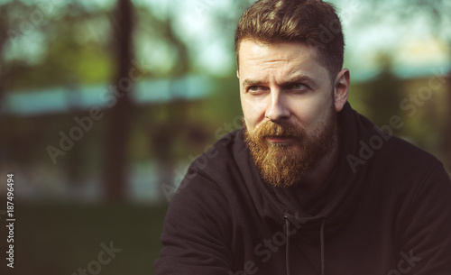 Outdoor portrait of bearded middle-aged hipster guy