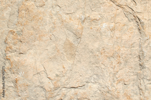 Beige rustic stone wall of a coastal village house
