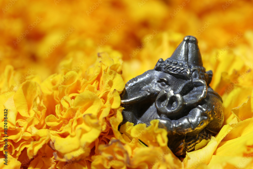 Mini Ganesha made from brass among of yellow marigold flower, the son