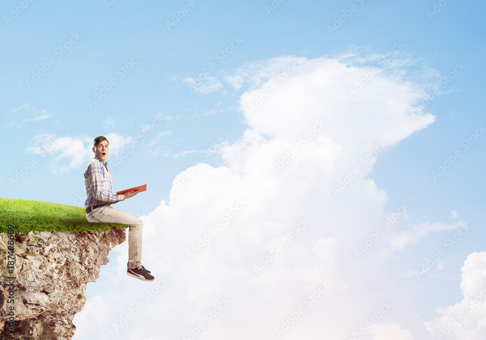 Student guy with book in hands preparing for exam Student guy with book in hands preparing for exam