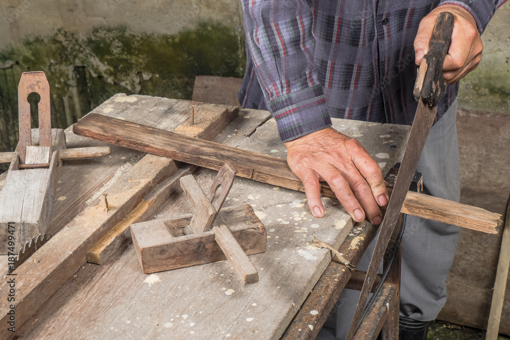 Hands of a carpenter planed wood, workplace 