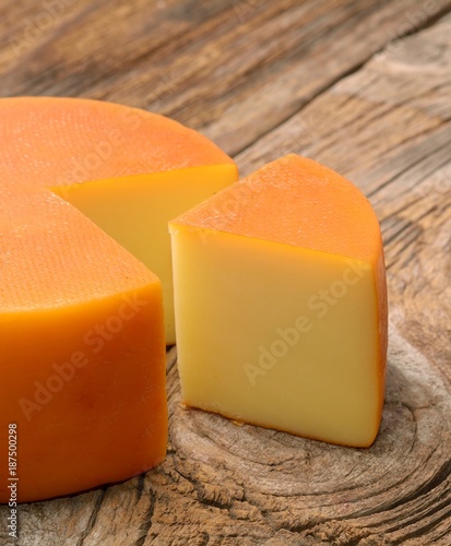 piece of cheese on wooden table