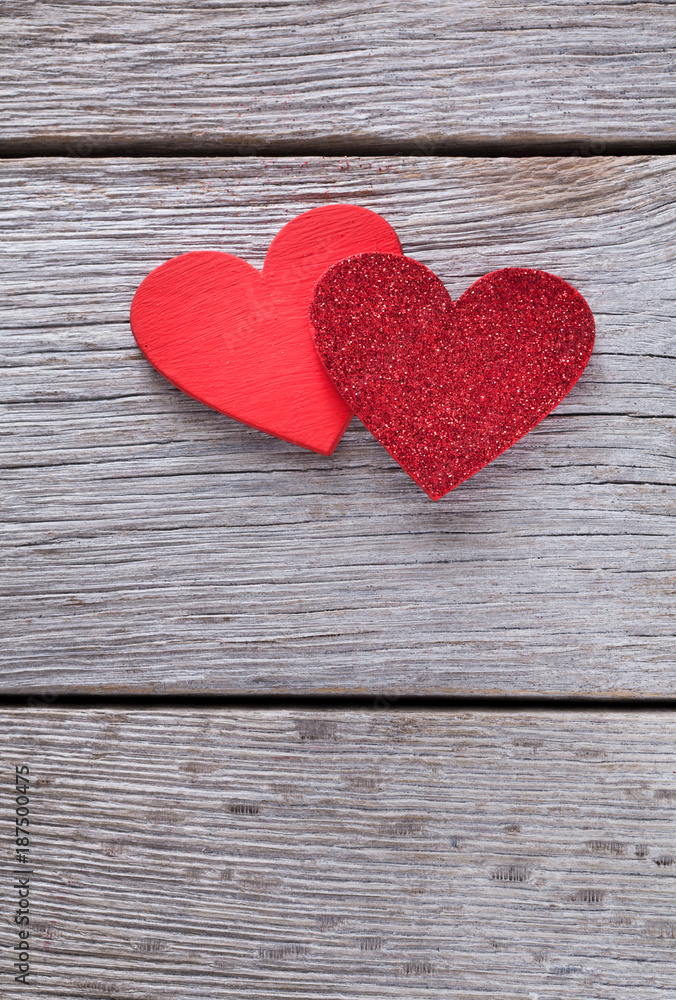 Valentine background with handmade glitter hearts on rustic wood Valentine background with handmade glitter hearts on rustic wood