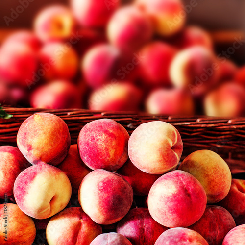 Organic fresh ripe peaches  a local farmer market.  Nectarines on display stall. Healthy local food market concept.