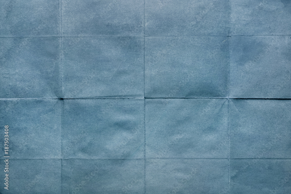Fototapeta premium Old crumpled sheet of paper, texture blue background