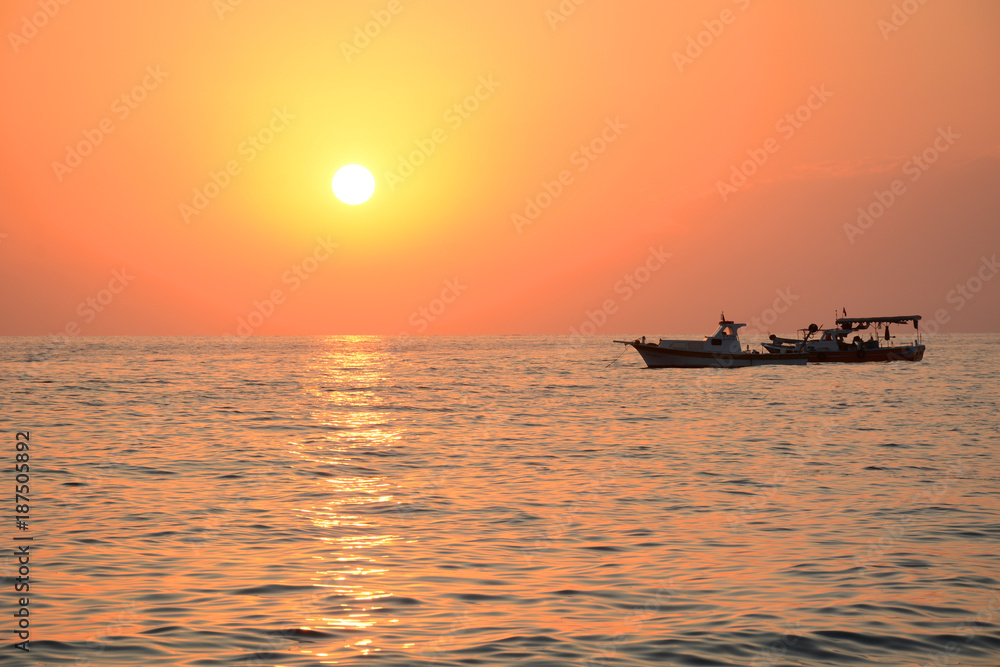 Mediterranean Sea sunset and boat floating