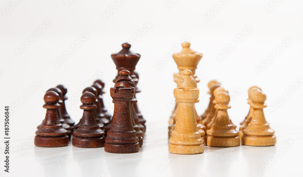 Business concept - chess - white team against black team - competition Business concept - chess - white team against black team - competition