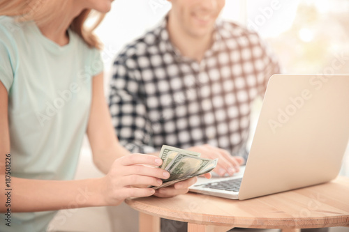 Young couple with laptop an...