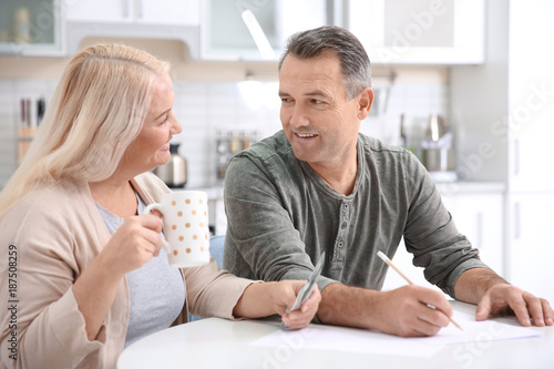 Mature couple managing fami...