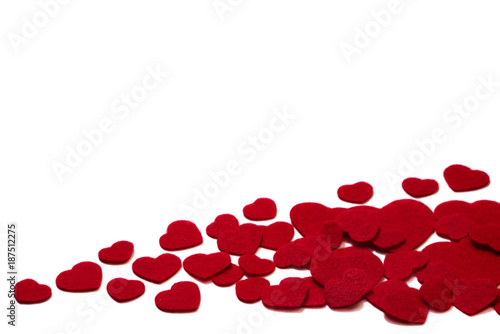 Scattered pile of red felt hearts isolated on a white background - valentines, love