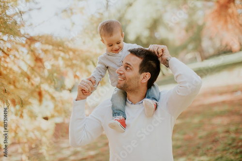 Young father and baby boy in autumn park