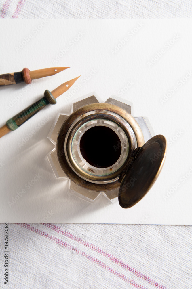 Calligraphy pens on white paper with blank space for a message Calligraphy pens on white paper with blank space for a message