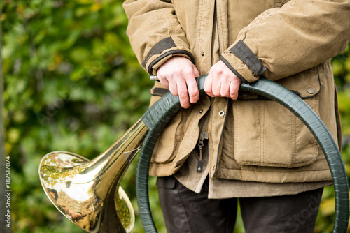 фотографія French horn band held in hands by a hunter on Saint Hubertus Day, 05/11/2017, De