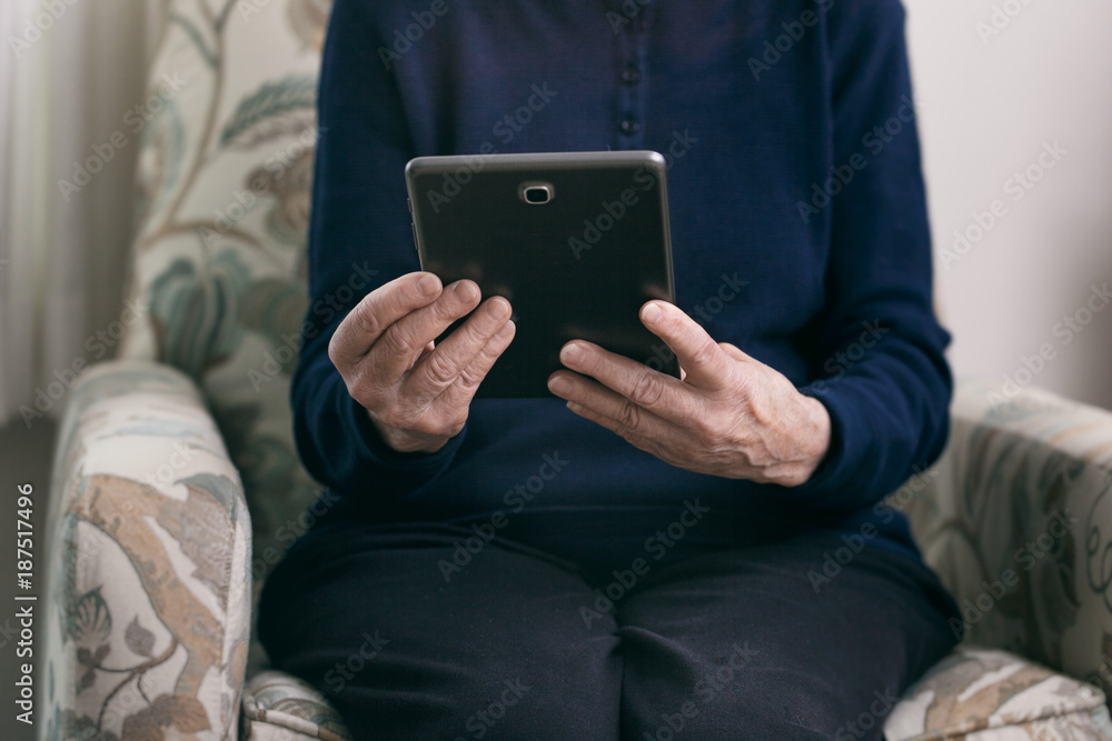 Senior: Woman Sits In Chair Using Digital Tablet Senior: Woman Sits In Chair Using Digital Tablet