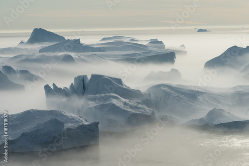 Stranded icebergs in the fog at the mouth of the Icefjord near Ilulissat, Greenland