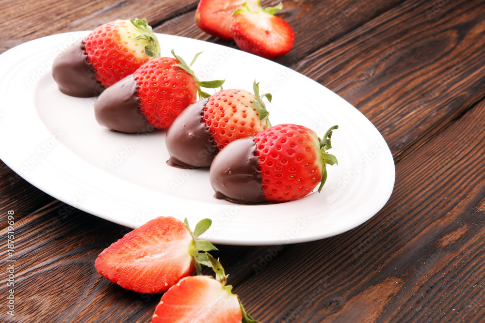 Chocolate dipped strawberries at dessert bar on white plate. Chocolate dipped strawberries at dessert bar on white plate.