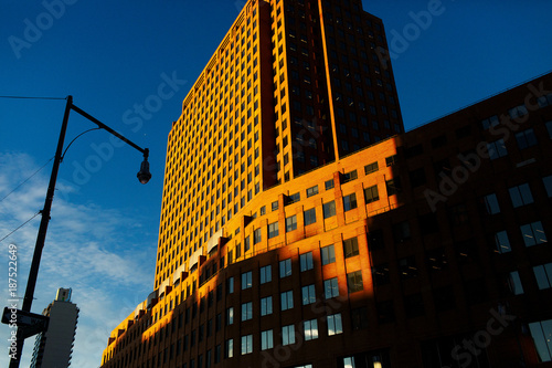 Yellow morning light shines over the skyscraper somewhere in New York