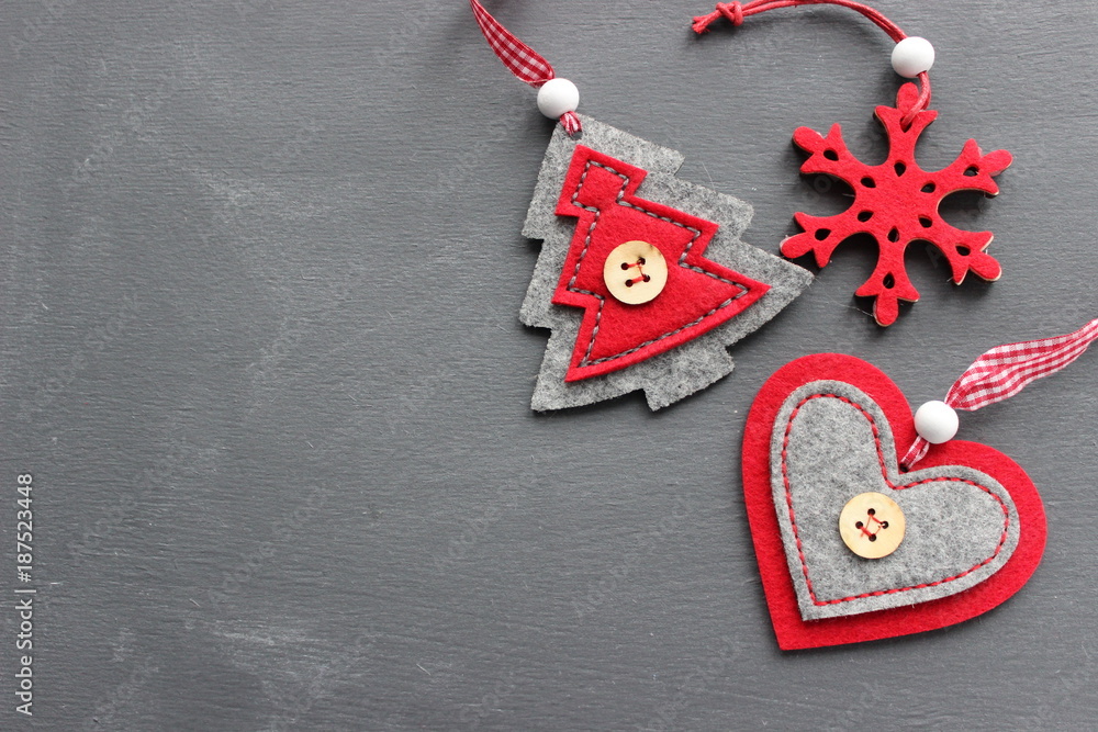 Three Christmas toys from wool on grey wood background closeup. You can use as the background Three Christmas toys from wool on grey wood background closeup. You can use as the background