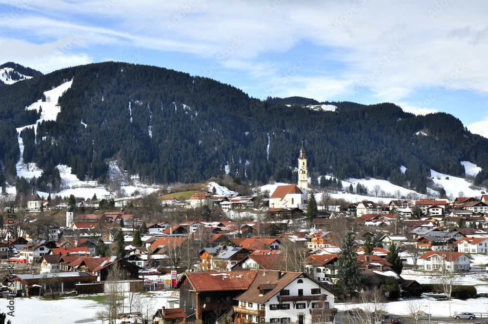 The view of nature in the early spring of the commune in Germany, in Bavaria called Pfronten, located on the border with Austria, in the valley surrounded by the Alps. The village has a beautiful whit