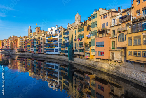 Colorful river-front houses lining the Onyar river, mostly built on top of old medieval defense walls, Girona, Catalonia, Spain