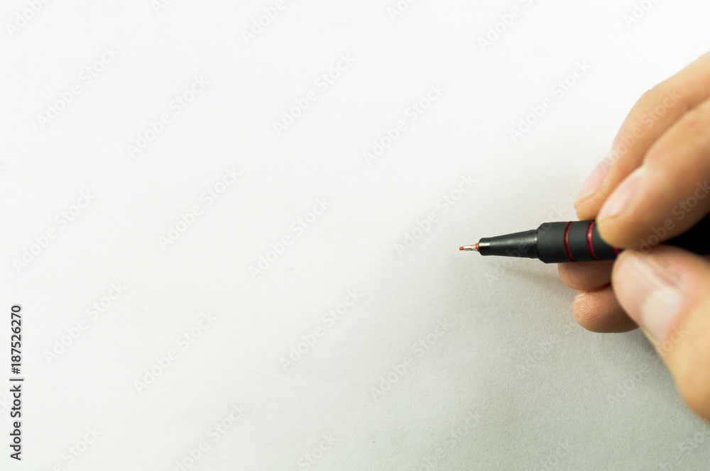 Mock pen in hand on white sheet of paper Mock pen in hand on white sheet of paper
