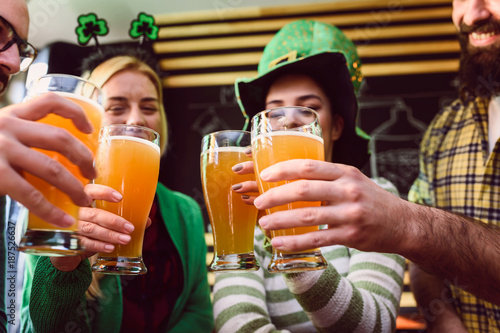 Photography Group of Friends Celebrating St Patrick's Day in Beer Pub