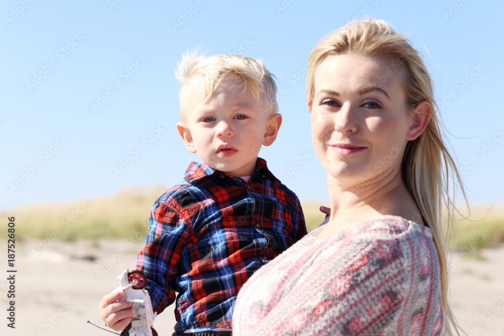 Mother and child at the beach on a sunny day.