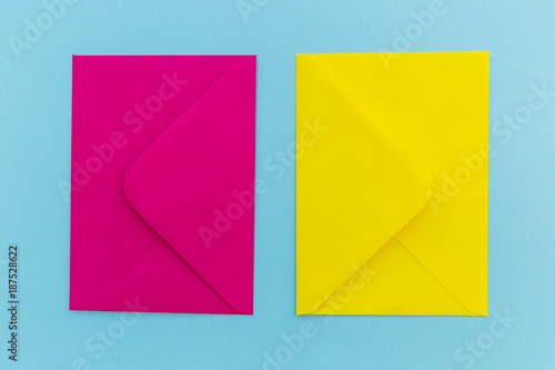Colorful pink and yellow envelopes on blue background