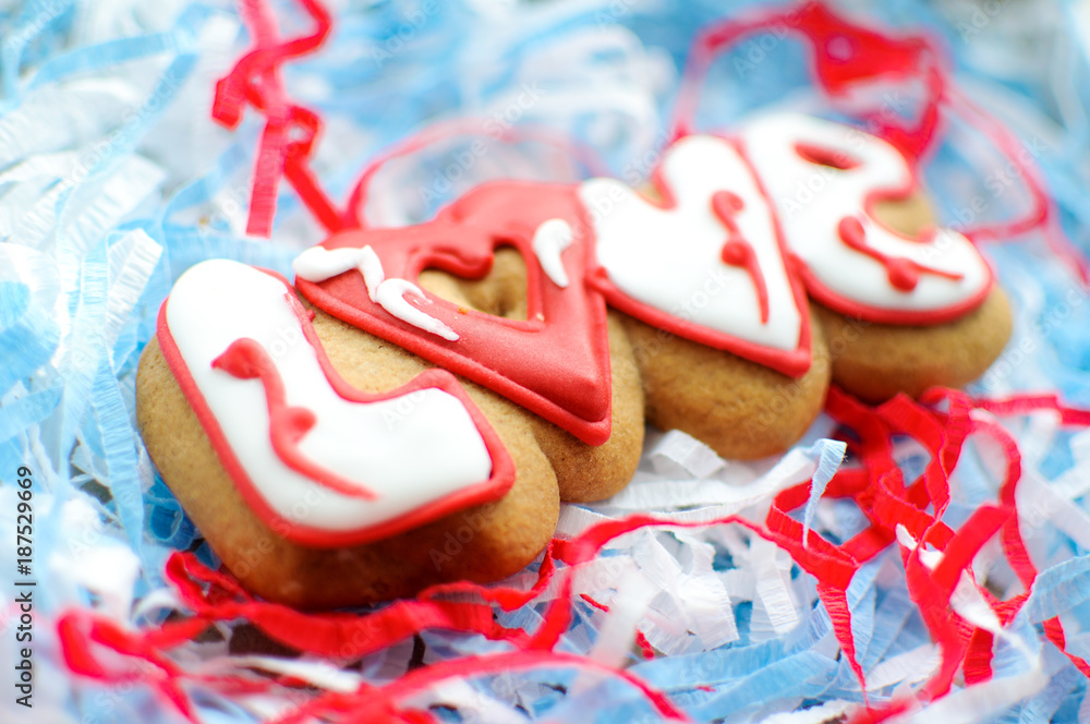 Letter cookies for Valentine's day or for a wedding day on the blue and white paper filler background. Letter cookies for Valentine's day or for a wedding day on the blue and white paper filler background.