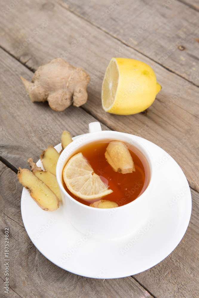 Ginger tea in a cup on wooden background Ginger tea in a cup on wooden background
