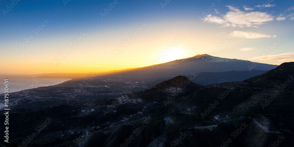 Sunset over the volcano Mount Etna and the gulf of Catania viewed from Taormina, Sicily, Italy, Europe